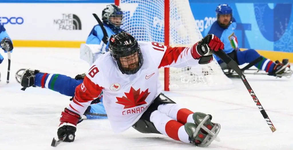 Canadian player in the middle of a game of Sledge Hockey