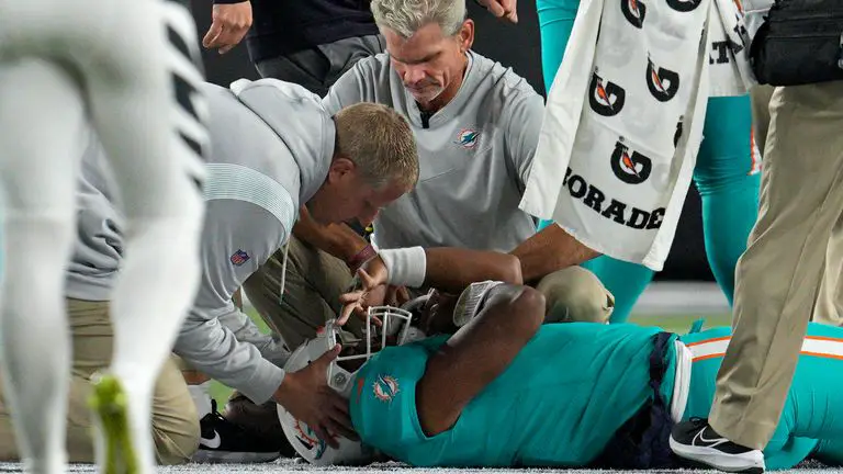 Tua Tagovailoa being inspected by the Dolphins medical team checking for brain injuries